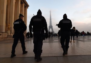 French gendarmes patrol in front of the Eiffel Tower one day before New Year's eve festivities in Paris on Dec. 30, 2016. (Credit: Miguel Medina/AFP/Getty Images)