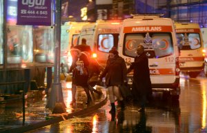 People flee as ambulances arrive on the attack site on Jan. 1, 2017, in Istanbul. (Credit: Ihlas News Agency / AFP / Getty Images)