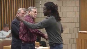 Rakeem Jones, left, shakes hands with James Franklin McGraw before the pair hugged in court on Dec. 14, 2016. (Credit: CNN)
