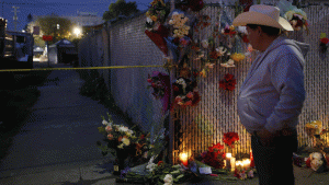 A makeshift memorial of flowers and candles stands Dec. 4 near the site of the Oakland warehouse fire. (Credit: Francine Orr / Los Angeles Times) 