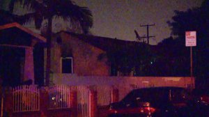 A Paramount home is damaged by fire after a man fought with deputies there on Dec. 1, 2016. (Credit: KTLA)