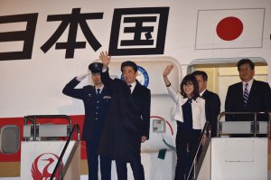 Japan's Prime Minister Shinzo Abe (second left) and Defense Minister Tomomi Inada (third left) wave as they depart for Hawaii at Tokyo's Haneda airport on December 26, 2016. (Credit should read KAZUHIRO NOGI/AFP/Getty Images)