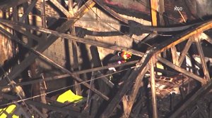 Recovery crews can be seen working inside the gutted building on Dec. 4, 2016. (Credit: KGO)