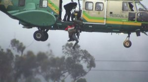 A woman is rescued from the San Gabriel River on Dec. 16, 2016. (Credit: KTLA)