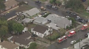 Police and fire vehicles surround a home in San Fernando where one person was apparently dead and at least one other person was injured in a shooting on Dec. 23, 2016. (Credit: KTLA)
