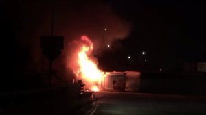 A truck overturned and caught fire on the 605 Freeway on Dec. 8, 2016, blocking four lanes. (Credit: John Lewis)
