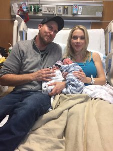 Holly and Brandon Shay hold their newborn twins, Sawyer and Everett, who were born in different years. (Credit: Nick Oza/The Arizona Republic)