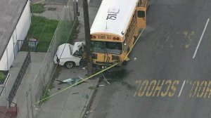 A school bus ended up on top of a car in the Harvard Park neighborhood of South Los Angeles on Jan. 27, 2017. (Credit: KTLA)