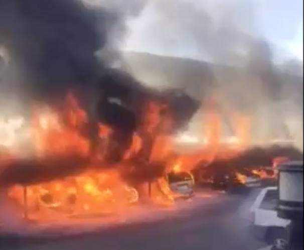 A carport fire that destroyed five vehicles and damaged five others on Jan. 27, 2017 is seen in cellphone video obtained by OC Hawk. 