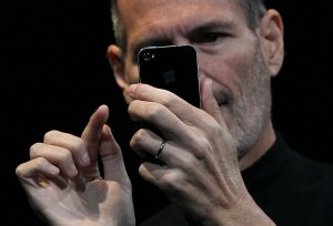 Apple CEO Steve Jobs demonstrates the new iPhone 4 as he delivers the opening keynote address at the 2010 Apple World Wide Developers conference June 7, 2010, in San Francisco. (Credit: Justin Sullivan / Getty Images)