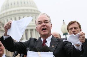 Rep. Tom Price, R-Georgia, tears a page from the national health care bill during a press conference at the U.S. Capitol March 21, 2012 in Washington, DC. (Credit: Win McNamee/Getty Images)