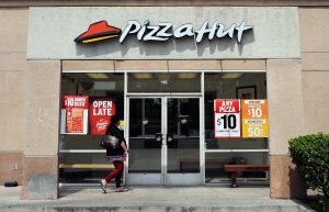 A customer walks in to a Pizza Hut restaurant during lunchtime on April 19, 2012 in Los Angeles. (Credit: Kevork Djansezian/Getty Images) 