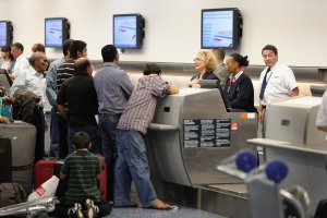 American Airlines passenger are helped at the ticket counter at Miami International Airport on April 16, 2013 in Miami, Florida. (Credit: Joe Raedle/Getty Images)