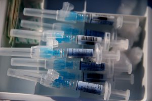 Syringes filled with flu vaccine sit on a table during a drive-thru flu shot clinic at Doctors Medical Center on Nov. 6, 2014 in San Pablo, California. Doctors Medical Center hosted a drive-thru flu shot clinic offering free vaccines for any community member over the age of 18. (Credit: Justin Sullivan/Getty Images)