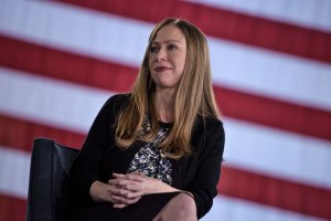 Chelsea Clinton listens as her mother Democratic presidential nominee Hillary Clinton speaks during a town hall meeting October 4, 2016 in Haverford, Pennsylvania. (Credit: BRENDAN SMIALOWSKI/AFP/Getty Images)