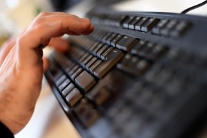 A file photo shows a person typing on a computer keyboard. (Credit: KIRILL KUDRYAVTSEV/AFP/Getty Images)