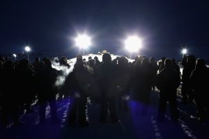 Military veterans, most of whom are native American, confront police guarding a bridge near Oceti Sakowin Camp on the edge of the Standing Rock Sioux Reservation on Nov. 30, 2016, outside Cannon Ball, North Dakota. (Credit: Scott Olson / Getty Images)