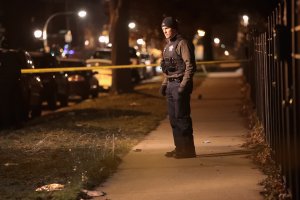 Police investigate the scene where a 23-year-old woman was shot in the chest and hand and a 25-year-old man was shot in the leg on Jan, 1, 2017, in Chicago, Illinois. (Credit: Scott Olson/Getty Images)