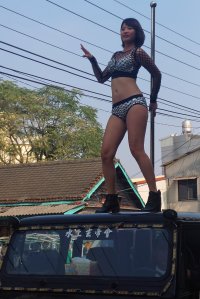 This picture taken on Jan. 3, 2017, shows a pole dancer performing on top of a jeep during the funeral procession of former Chiayi City county council speaker Tung Hsiang in Chiayi City, southern Taiwan. (Credit: STR / AFP / Getty Images)