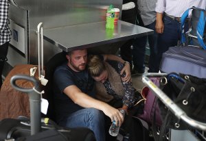 People wait at the Fort Lauderdale-Hollywood International airport after a shooting took place near the baggage claim on Jan. 6, 2017. (Credit: Joe Raedle / Getty Images)