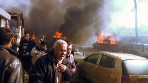 An image grab taken from an AFPTV video released on Jan. 7, 2017, shows people gathering amidst debris at the site of a car bomb attack in the rebel-held town of Azaz in northern Syria. (Credit: Stringer / AFP / Getty Images)