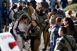 An Israeli soldier is consoled as she cries at the site of a vehicle-ramming attack in Jerusalem on Jan. 8, 2017. (Credit: Ahmad Gharabli / AFP / Getty Images)