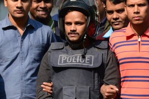 Bangladesh police escort alleged Islamist militant Jahangir Alam (C) in Dhaka on Jan. 14, 2017, after his arrest in connection with an attack on the Holey Artisan Bakery attack last year. (Credit: STR/AFP/Getty Images)