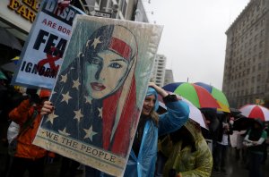 A protester holds a sign during a demonstration against U.S. President Donald Trump on Jan. 20, 2017, in Los Angeles. (Credit: Justin Sullivan/Getty Images)