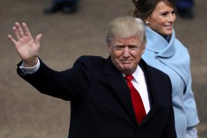 U.S. President Donald Trump waves to supporters as he walks the parade route with first lady Melania Trump during the Inaugural Parade on Jan. 20, 2017, in Washington, D.C. (Credit: Patrick Smith/Getty Images)