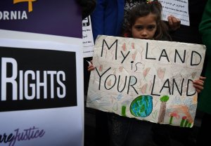 Maya Casillas, 7, joins an immigrant rights group during a vigil to protest against President Donald Trump's new crackdown on "sanctuary cities" outside Los Angeles City Hall on Jan. 25, 2017. (Credit: MARK RALSTON/AFP/Getty Images)