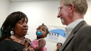 Philip Browning, head of the county Department of Children and Family Services, listens to a woman who cares for her granddaughter after a 2012 talk to caregivers in South Central. (Credit: Jay L. Clendenin / Los Angeles Times)