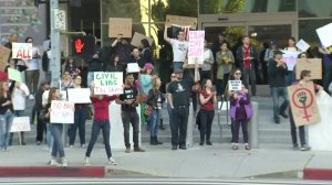 Demonstrators gather outside the US Citizenship and Immigration Services field office in Los Angeles on Jan. 28, 2017. (Credit: KTLA) 