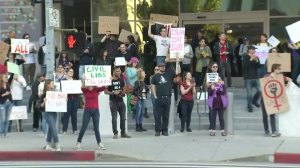 Demonstrators gather outside the US Citizenship and Immigration Services field office in Los Angeles on Jan. 28, 2017. (Credit: KTLA)