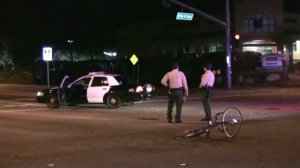 Los Angeles County Sheriff's deputies survey the scene after a bicyclist collided with a patrol vehicle on Jan. 4, 2017. (Credit: Ed Frommer)