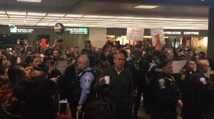 Sen. Cory Booker speaks to protesters at Washington Dulles International Airport demonstrate against Pres. Trump's travel ban. (Credit: CNN)