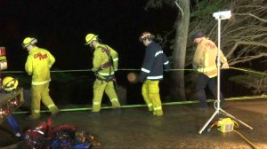 Fire crews in San Luis Obispo County tape off a section of Highway 1 on Jan 4, 2017, after a car was found off a cliff near San Simeon. (Credit: KEYT)