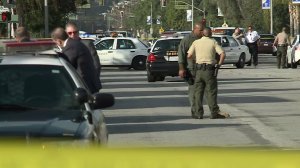 Los Angeles County Sheriff's Department officials investigate after a woman was stabbed to death with a samurai sword in Temple City on Jan. 11, 2017. (Credit: KTLA)