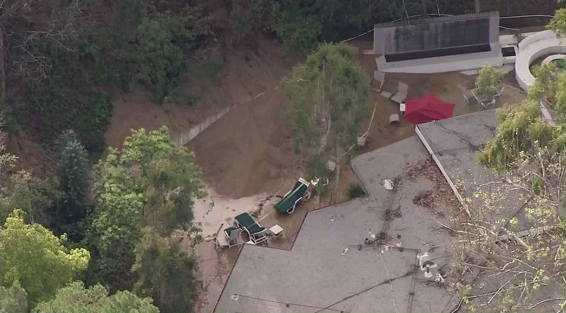 The backyard of a home in Beverly Crest was damaged after a water main break apparently caused mud to slide down a hillside on Feb. 13, 2017. (Credit: KTLA) 