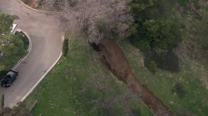 A water main break might be to blame for mud to slide down a hillside in Beverly Crest on Feb. 13, 2017. (Credit: KTLA) 