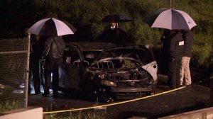 Detectives investigate after a body was found in a burned fire in Chatsworth on Feb. 26, 2017. (Credit: KTLA)