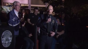 Whittier police Chief Jeff Piper, right, speaks at a vigil for Officer Keith Boyer while Whittier Mayor Joe Vinatieri, left, holds a candle on Feb. 20, 2017. (Credit: KTLA)