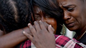 From left, Alice Corley, the mother of Lionel V. Gibson Jr., Tritobia Ford, the mother of Ezell Ford, and Pamela Fields, the mother of Dante Jordan, embrace at a protest for Ezell Ford outside a downtown L.A. courthouse on Aug. 11, 2016. All three mothers have lost children at the hands of police. (Credit: Callaghan O'Hare / Los Angeles Times)