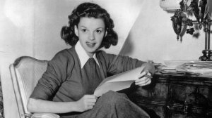 American film actress Judy Garland at home answering fan mail in 1944. (Credit: Hulton Archive / Getty Images)