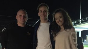 Two Georgia teens will be attending their school prom together after a police officer helped the young man ask the girl to go. (Credit: Alexis Fletcher via Bibb County Sheriff's Office/CNN Wire)