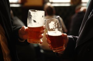 Drinkers enjoy a pint in a pub on March 11, 2011, in London, England. (Credit: Peter Macdiarmid / Getty Images)