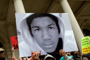 People along with New York City Council members attend a press conference to call for justice in the Feb. 26, 2012, killing of 17-year-old Trayvon Martin in Sanford, Florida, on the steps of City Hall March 28, 2012, in New York City. (Credit: Allison Joyce / Getty Images)