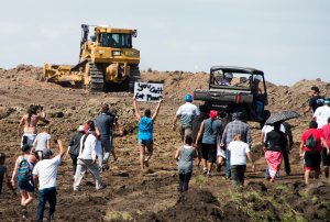 Native American protestors and their supporters are confronted by security during a demonstration against work being done for the Dakota Access Pipeline (DAPL) oil pipeline, near Cannon Ball, North Dakota, Sept. 3, 2016. (Credit: Robyn Beck / AFP / Getty Images)