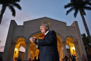 U.S. President Donald Trump watches the Palm Beach Central High School marching band perform as it greets him upon his arrival to watch the Super Bowl at Trump International Golf Club in West Palm Beach, Florida, on Feb. 5, 2017. (Credit: Mandel Ngan / AFP / Getty Images)