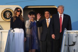 President Donald Trump and his wife Melania Trump arrive with Japanese Prime Minister Shinzo Abe and his wife Akie Abe on Air Force One at the Palm Beach International airport as they prepare to spend part of the weekend together at Mar-a-Lago resort on Feb. 10, 2017. (Credit: Joe Raedle / Getty Images)