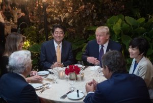 US President Donald Trump, Japanese Prime Minister Shinzo Abe (2nd-L), his wife Akie Abe (R), First Lady Melania Trump (L) and Robert Kraft (2nd-L),owner of the New England Patriots, sit down for dinner at Trump's Mar-a-Lago resort on Feb. 10, 2017. (Credit: Nicholas Kamm/AFP/Getty Images)